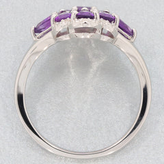 Elegant oval purple amethyst sterling silver ring featuring sparkling gemstones from a side view.