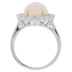 Elegant oval white opal sterling silver ring with sparkling gemstone accent, showcasing timeless beauty and luxury.