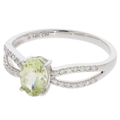 14K white gold ring featuring a green peridot gemstone and diamond accents, showcasing elegance and luxury.