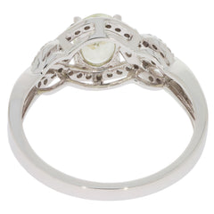14K white gold ring featuring a green peridot and diamond accents, showcasing elegant design and detailed craftsmanship.