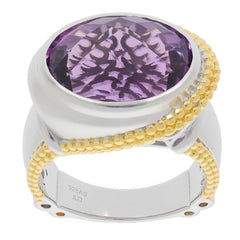 Oval purple amethyst ring in sterling silver and gold accents, featuring a sparkling gemstone design.