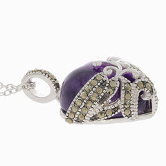 Heart-shaped purple amethyst pendant with silver accents, showcasing elegant gemstone detailing.