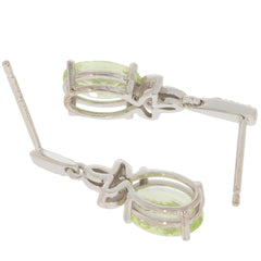 Oval green peridot earrings in 14K white gold with diamond accent, showcasing elegance and luxury.