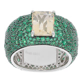 Elegant yellow Moissanite ring with emerald accents in sterling silver setting.