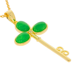 Elegant green jadeite pendant in a key design, set in gold, showcasing luxurious gemstones for a sophisticated look.