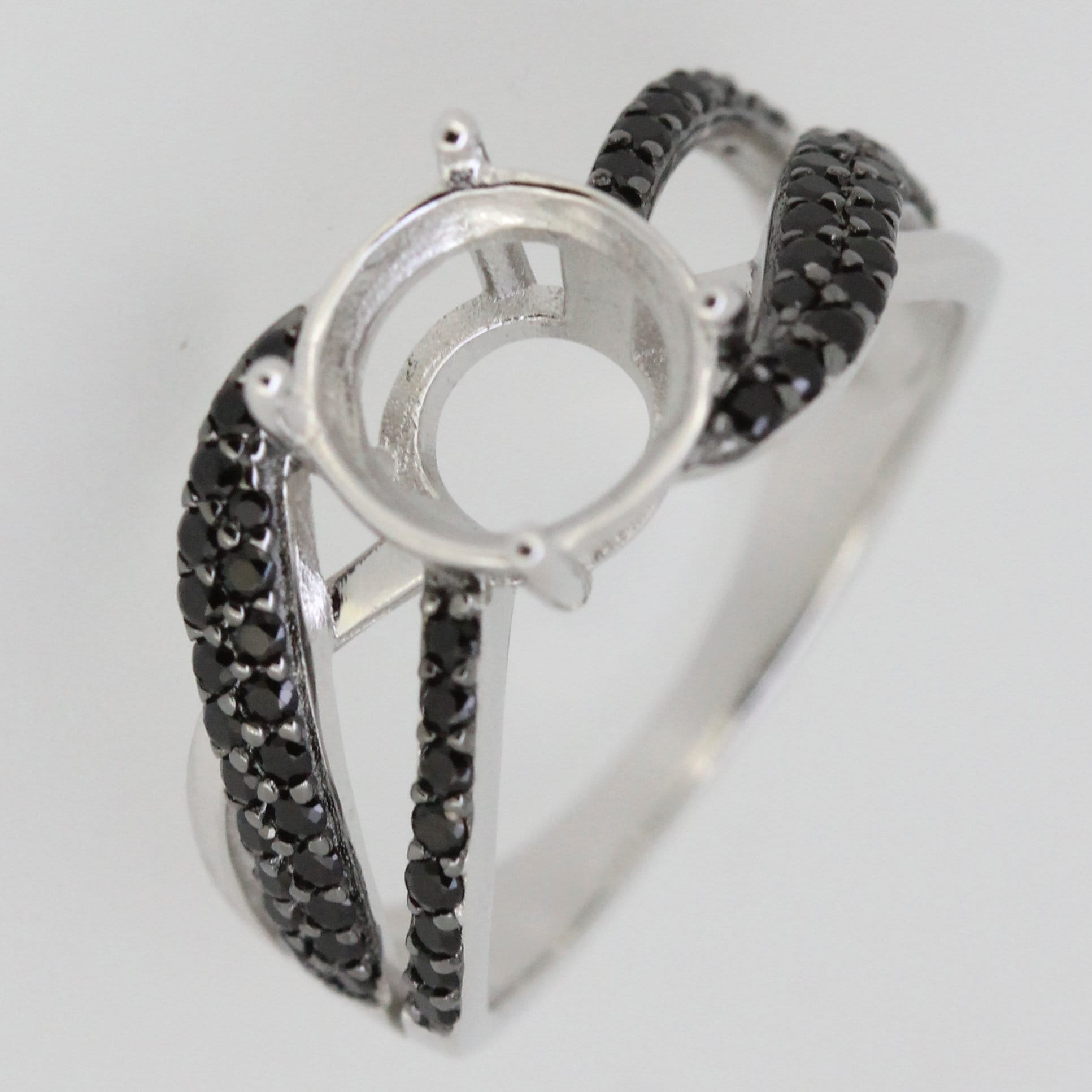 Sterling silver semi mount ring setting with black spinel accent on split shank design, ready for custom gemstone.