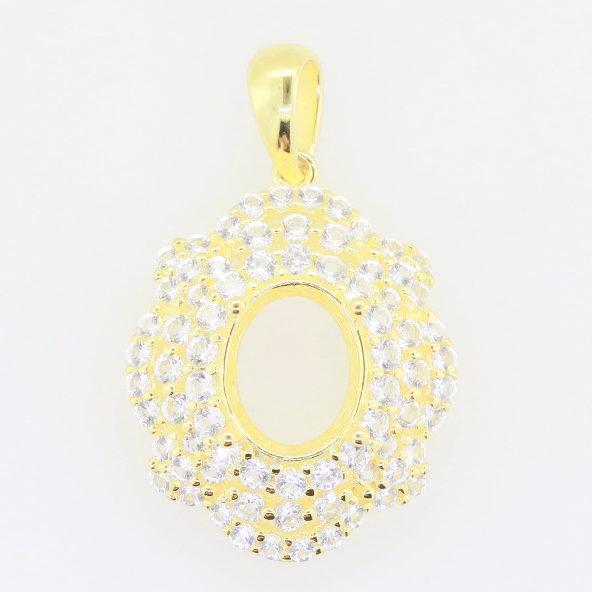 Elegant gold pendant setting with sparkling cubic zirconia, suitable for 10x8mm oval gemstone.