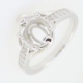 Sterling silver semi mount ring setting for 10x8mm oval gemstone, featuring sparkling White Topaz accents.