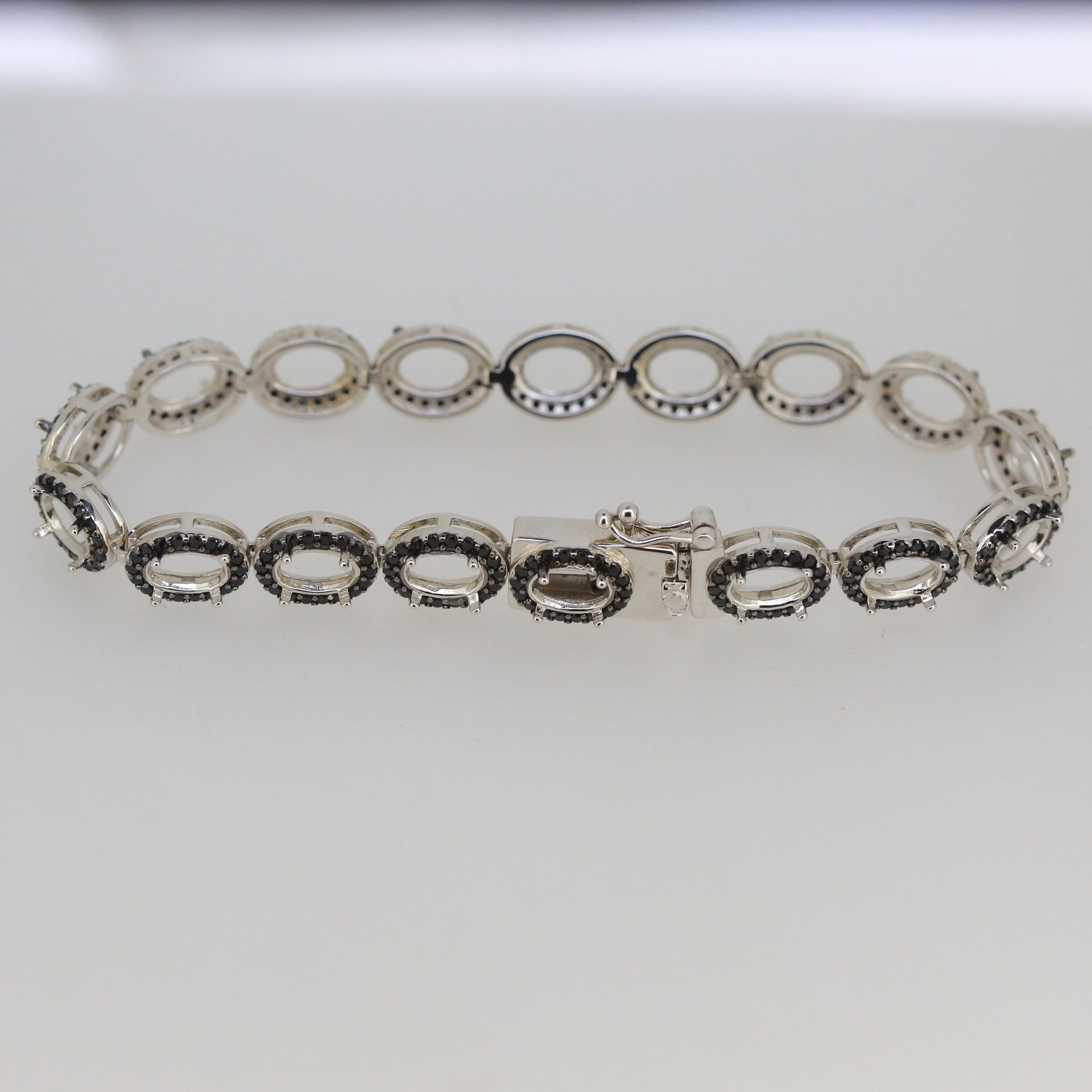 Sterling silver semi mount tennis bracelet setting with black spinel ovals, elegant and durable design.