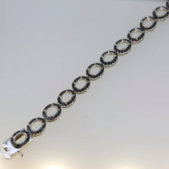 Sterling silver semi mount tennis bracelet setting with oval 6x4mm halo featuring black spinel accents.