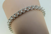 Sterling silver semi mount tennis bracelet setting, features round gemstone placeholders, elegant design for customization.