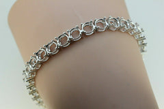 Sterling silver semi mount tennis bracelet setting with round 6x6mm gemstone placeholders.