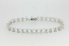 Custom sterling silver semi mount tennis bracelet setting with round stone placeholders.