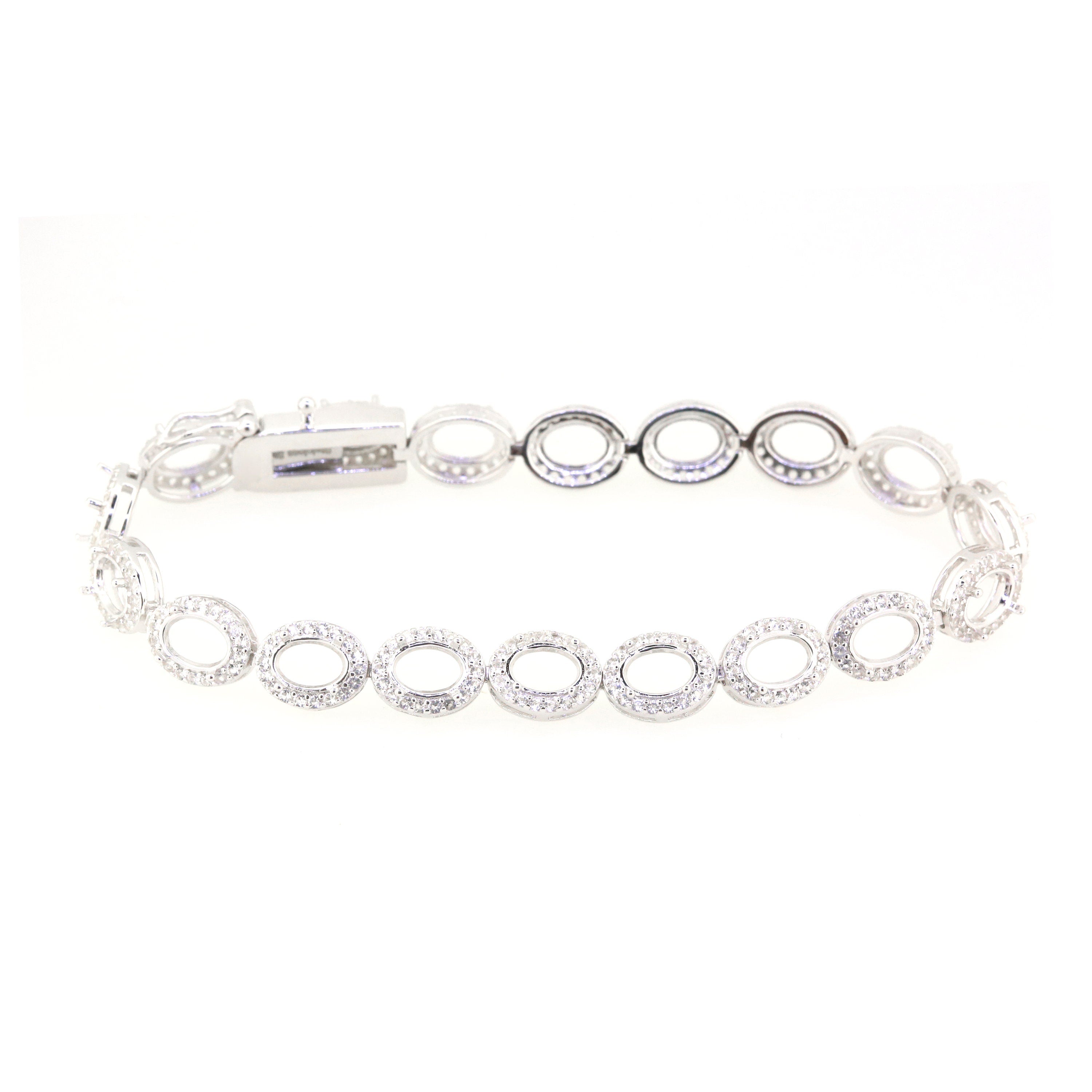 Sterling silver semi mount tennis bracelet setting with oval halo design and white topaz accents.