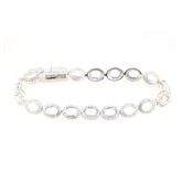 Sterling silver semi mount tennis bracelet setting with oval halo design and white topaz accents.