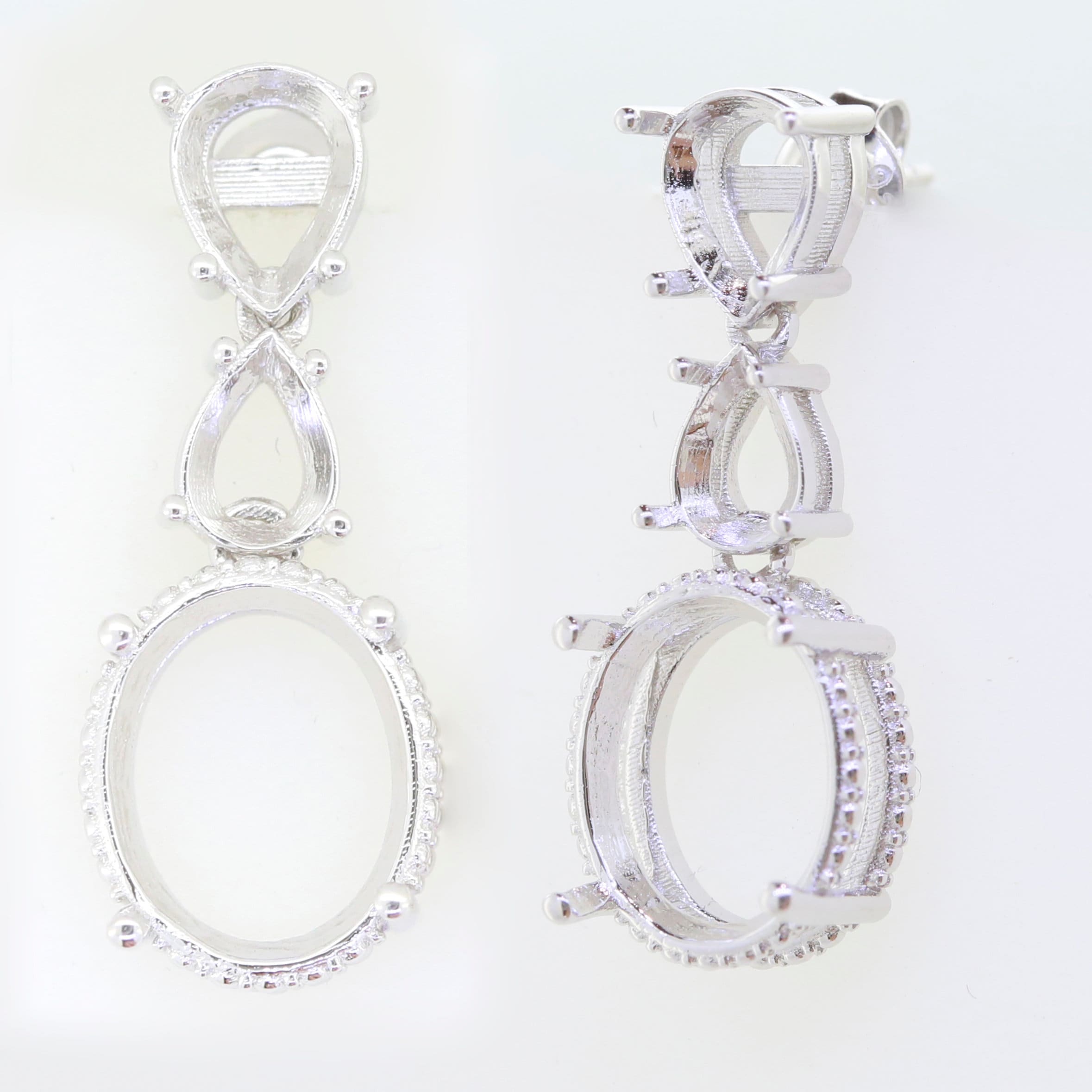 Sterling silver semi mount dangle earrings setting with white topaz, featuring oval and pear shapes for customizable gemstones.