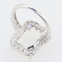 Custom sterling silver semi mount ring setting for 12x10mm emerald, featuring white topaz accents and intricate design.