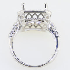 Custom sterling silver semi mount ring setting with intricate detailing, designed for 12x10mm emerald, accented with white topaz.