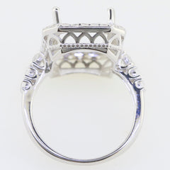 Sterling silver semi mount ring setting with intricate design and accent spaces for emerald and white topaz.