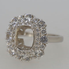 Sterling silver semi mount ring setting with white topaz halo, designed for a 10x8mm cushion gemstone.