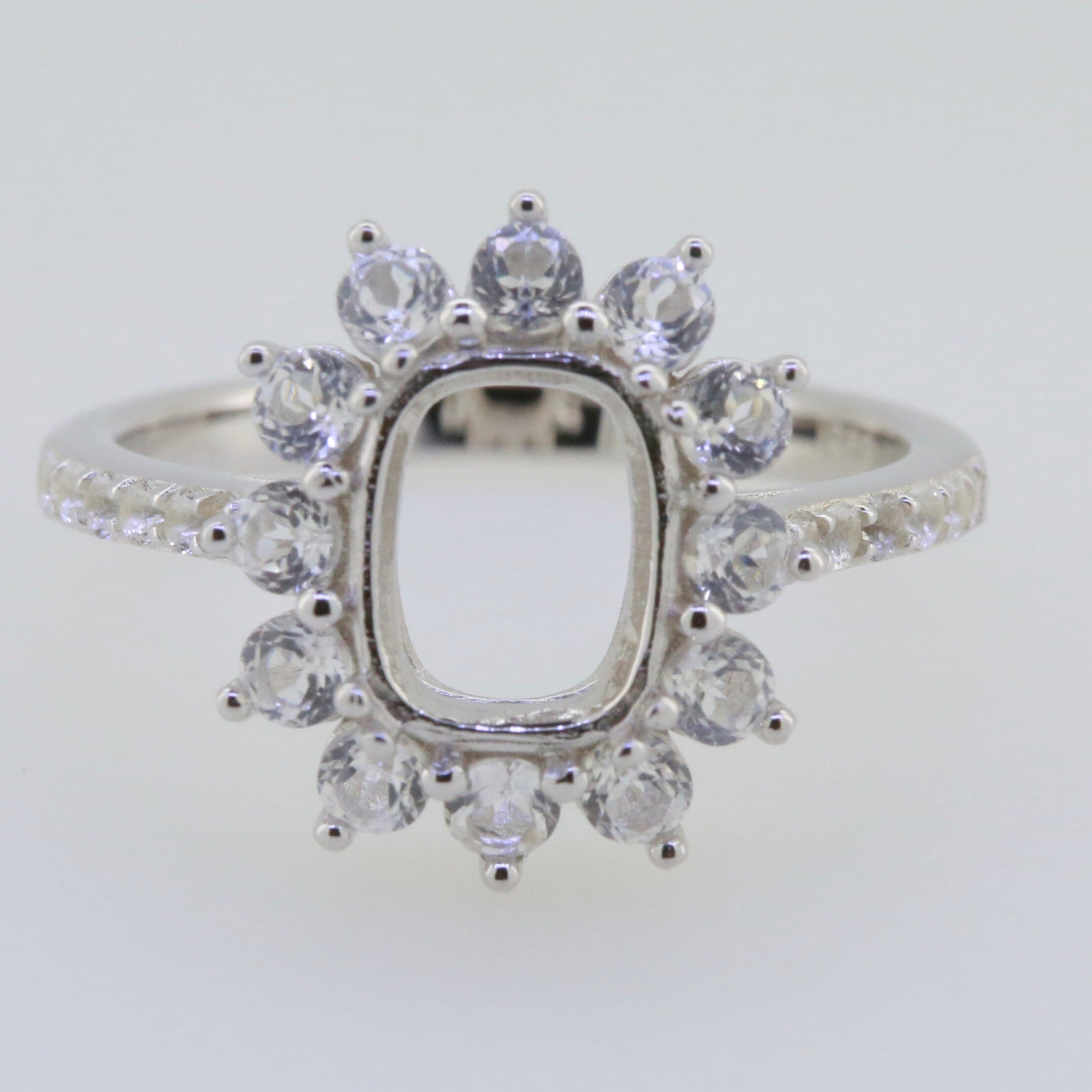 Sterling silver semi mount ring setting featuring an emerald cut halo with D color moissanite accent gemstones.