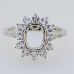 Sterling silver semi mount ring setting featuring an emerald cut halo with D color moissanite accent gemstones.