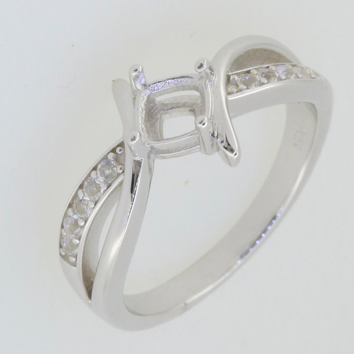 Sterling silver semi mount ring setting with cushion for 5x5mm gemstone and bypass split shank, featuring white topaz.