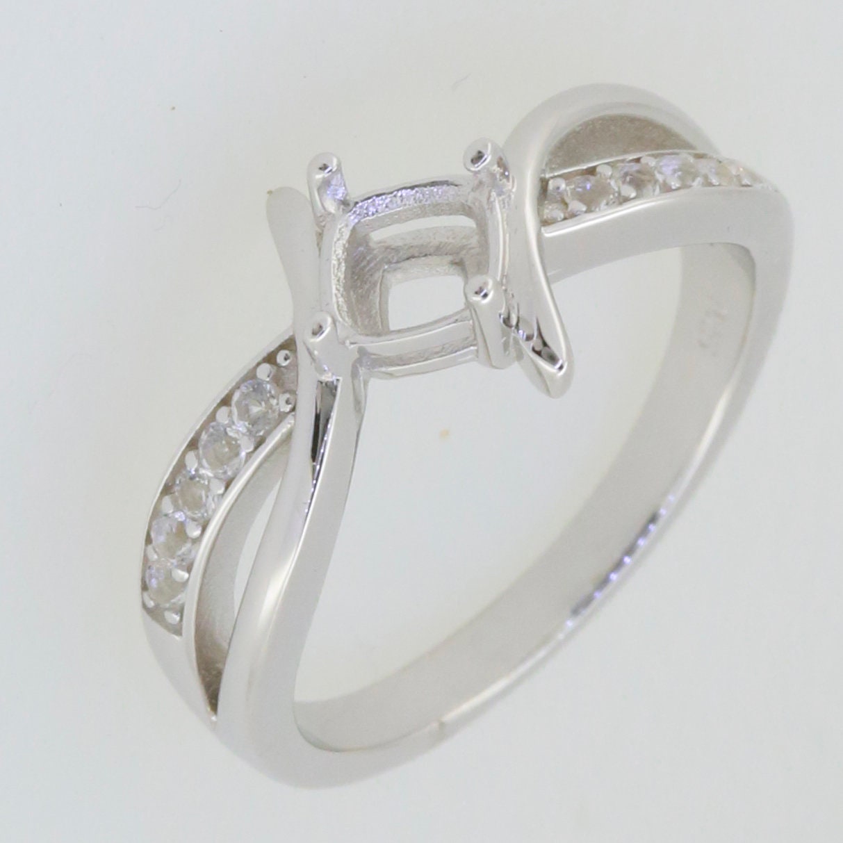 Custom sterling silver semi mount ring setting with bypass split shank, featuring white topaz gem accents.