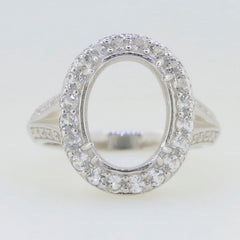 Sterling silver semi mount ring setting with oval halo and moissanite accents, designed for custom gemstone placement.