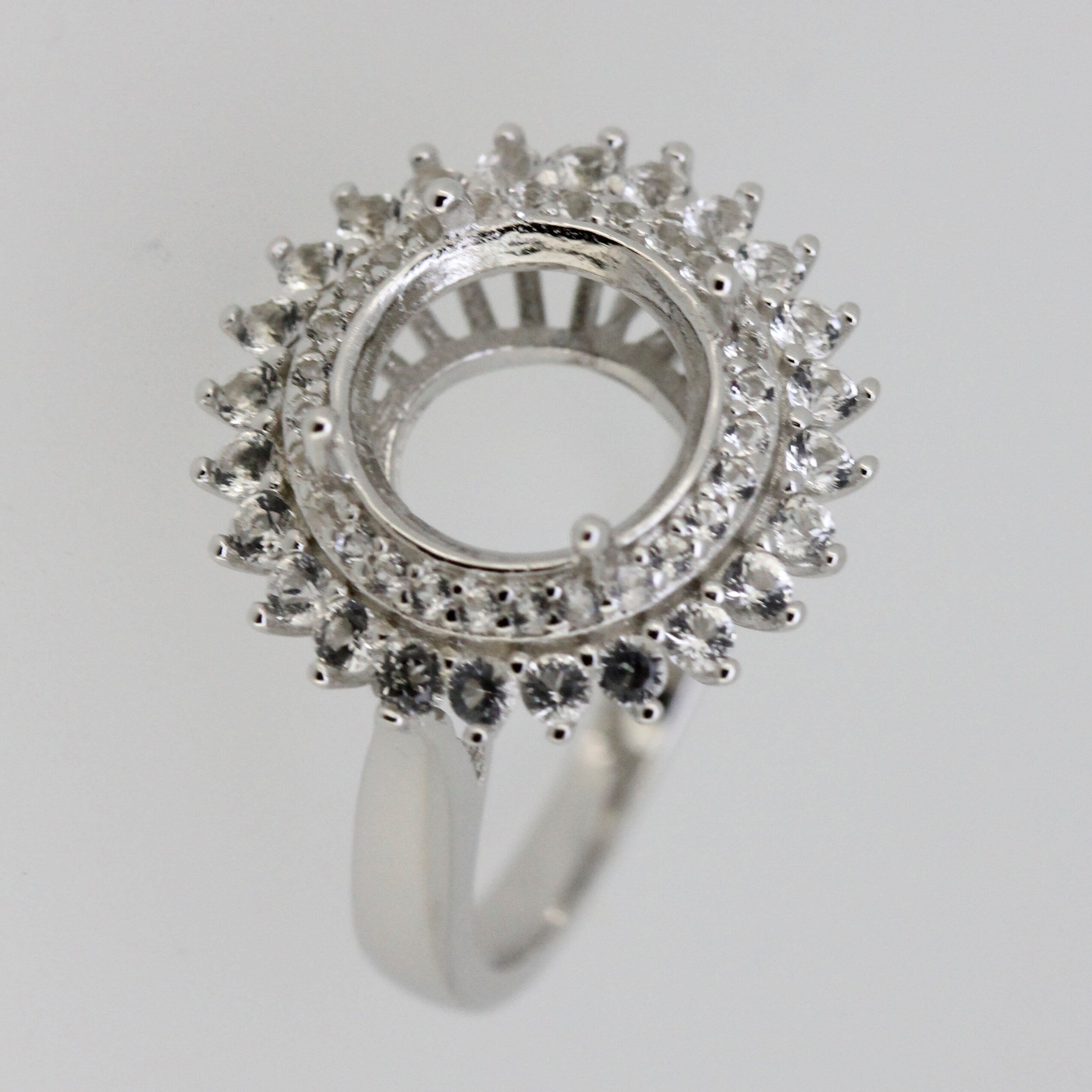 Sterling silver semi mount ring setting with double halo design and white topaz accents, ready for customization.