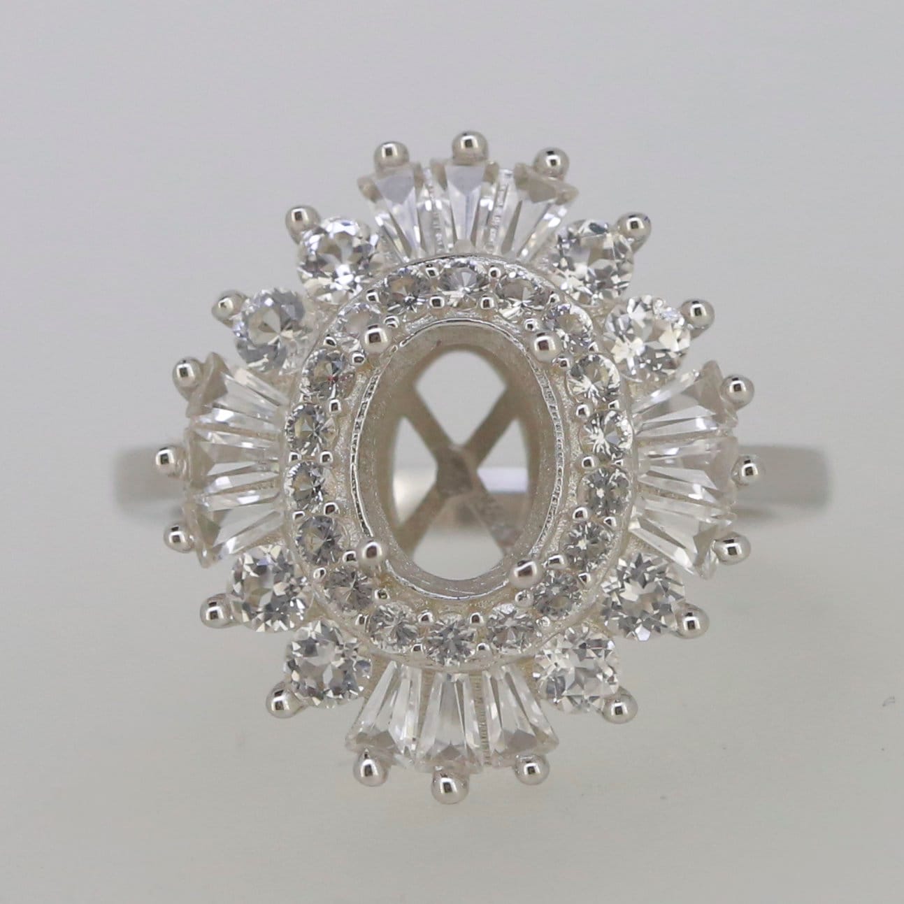 Sterling silver semi mount ring setting with white topaz and oval center for custom gemstone designs.