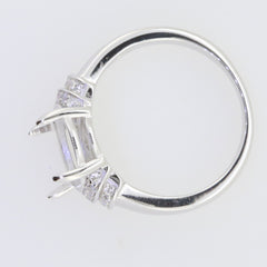 Sterling silver semi mount ring setting for 12x10mm oval cabochon with white topaz accents.
