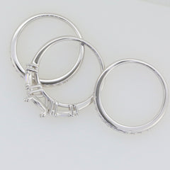 Three pieces of sterling silver semi mount rings with round settings for engagement and wedding.
