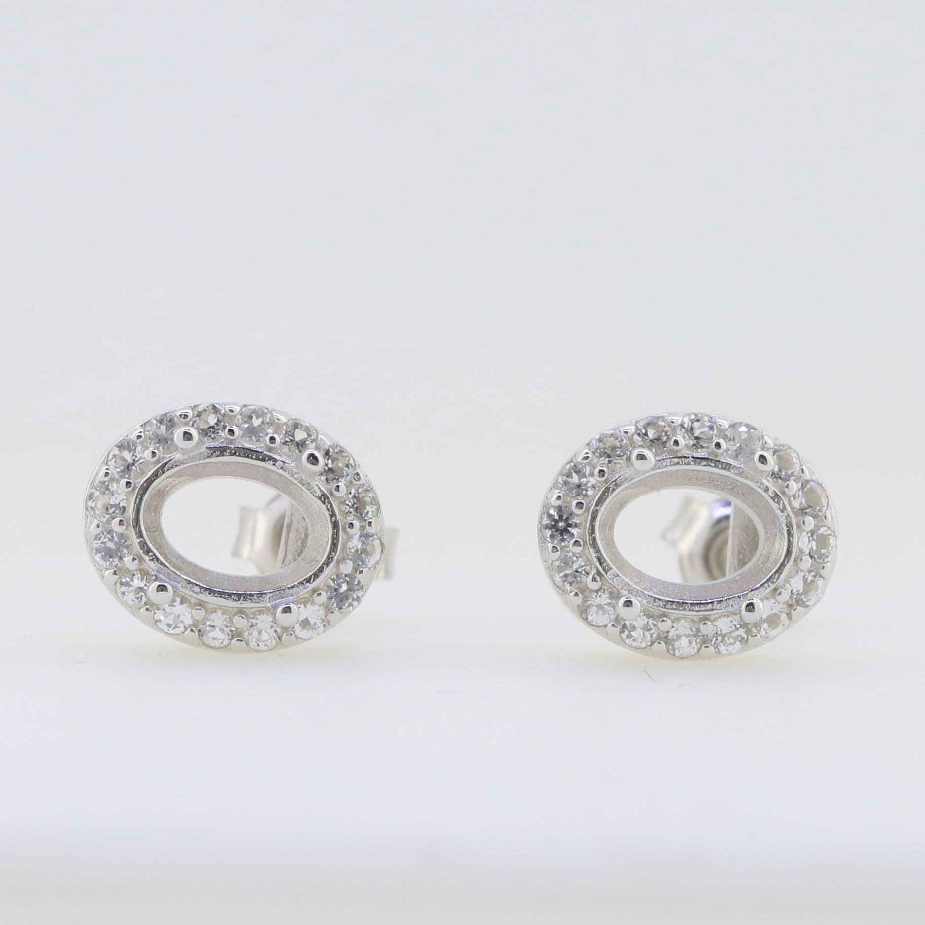 Sterling silver semi mount earrings setting with white topaz, oval 8x6mm, customizable design for personalized options.