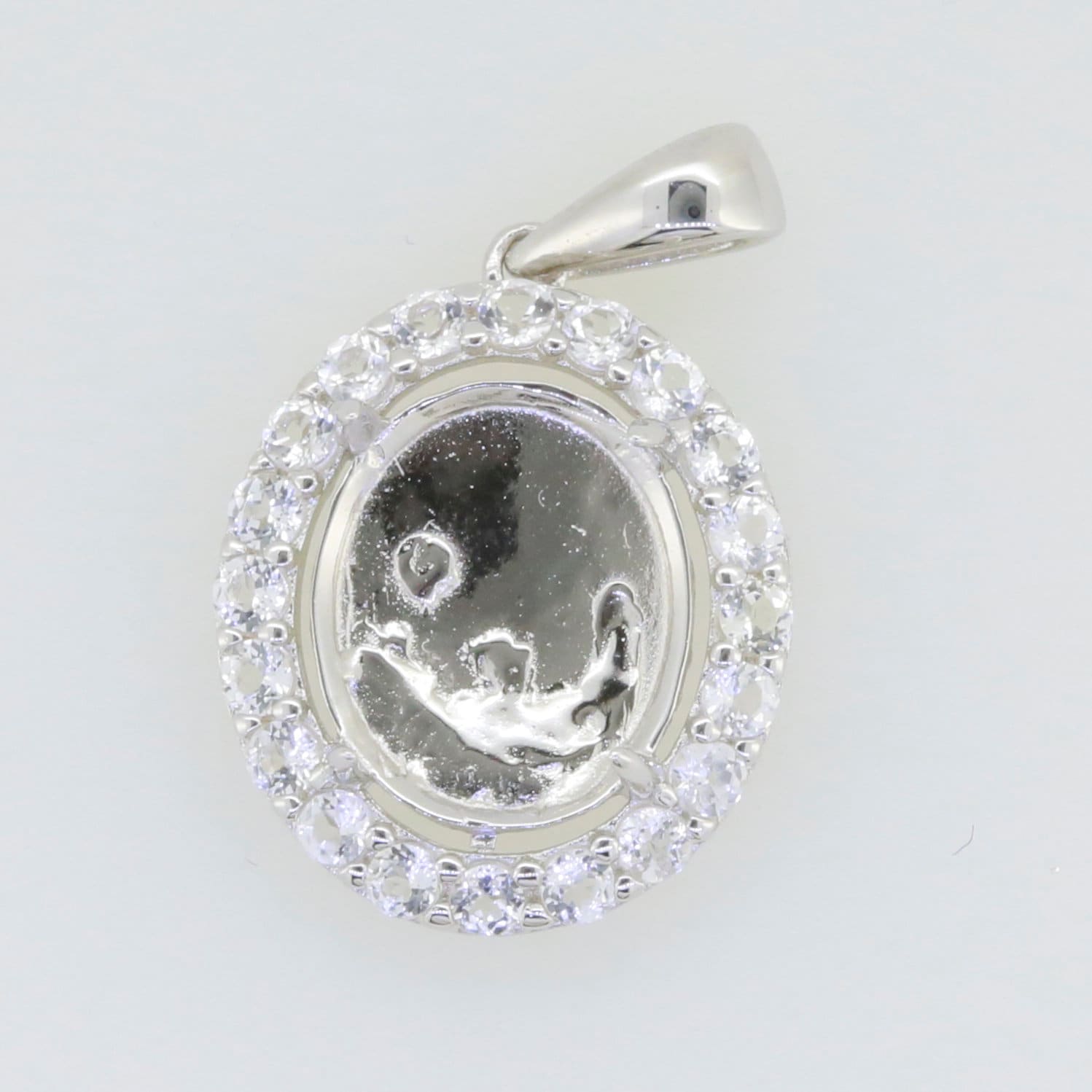 Sterling silver semi mount pendant setting with halo of white topaz cabochons, designed for custom gemstones.