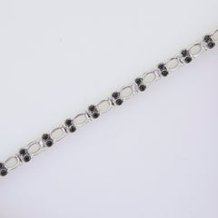 Sterling silver semi mount tennis bracelet setting featuring oval openings and black spinel accents.