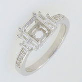 Sterling silver semi mount ring setting with white topaz accents, designed for an emerald cut gemstone.