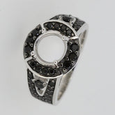 Sterling silver semi mount ring setting with round halo and black spinel accents, designed for custom gemstone fitting.