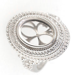 Sterling silver semi mount ring setting with halo design for 11x9mm oval cabochon, featuring intricate milgrain detail.