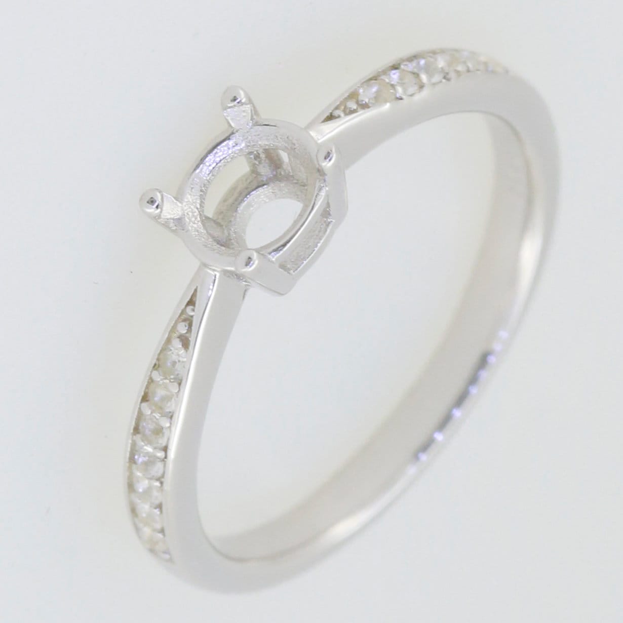 Sterling silver semi mount ring setting with round 5x5mm centerpiece and Moissanite accents, ideal for custom designs.