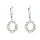 Sterling silver semi mount earrings with oval setting for cabochon, featuring white topaz accents and leverback closure.