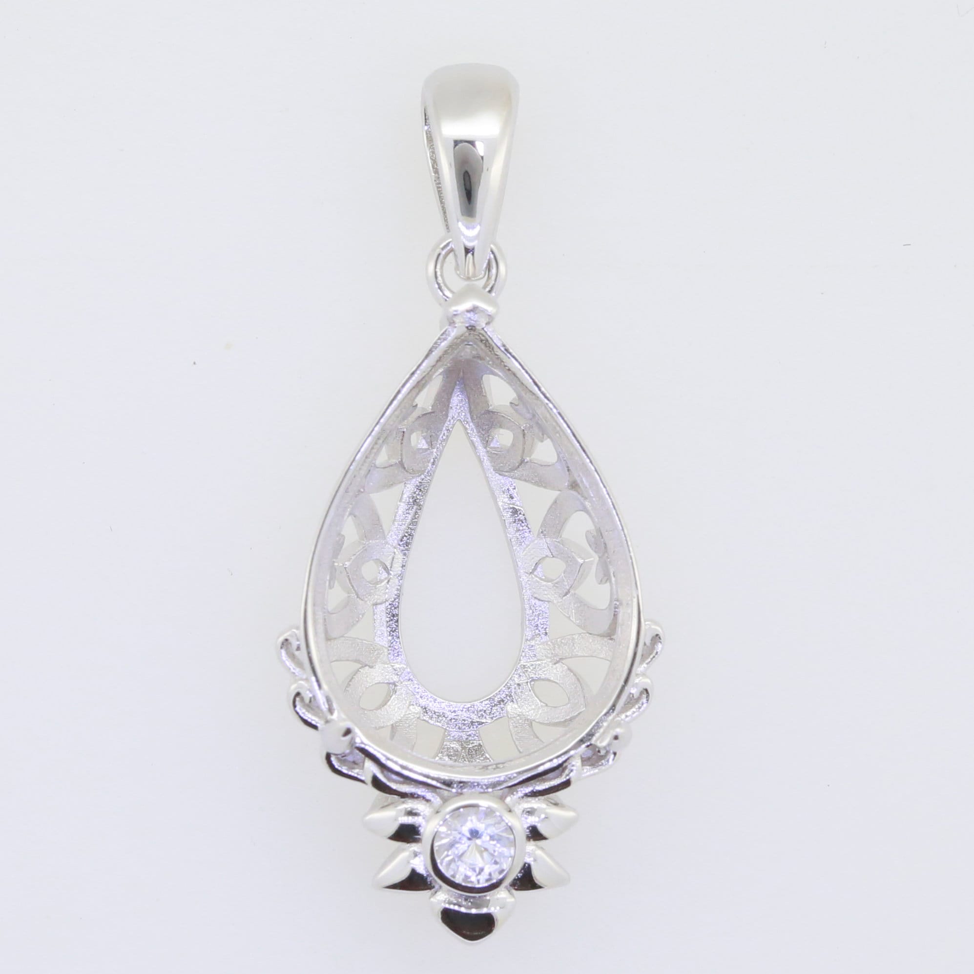 Sterling silver semi mount pendant setting with white topaz, designed for customizable gemstones in teardrop shape.
