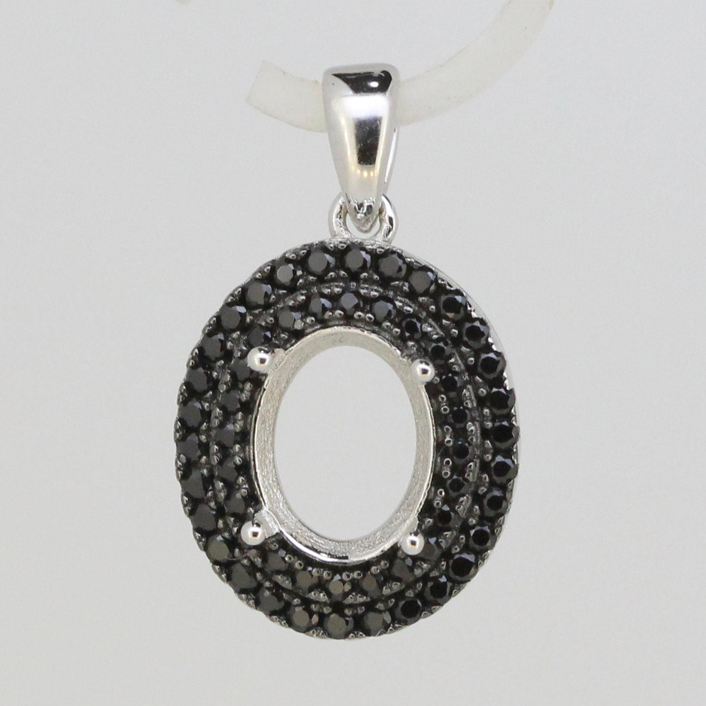 Sterling silver semi mount pendant setting with black spinel stones, designed for an oval gemstone 9x7mm.