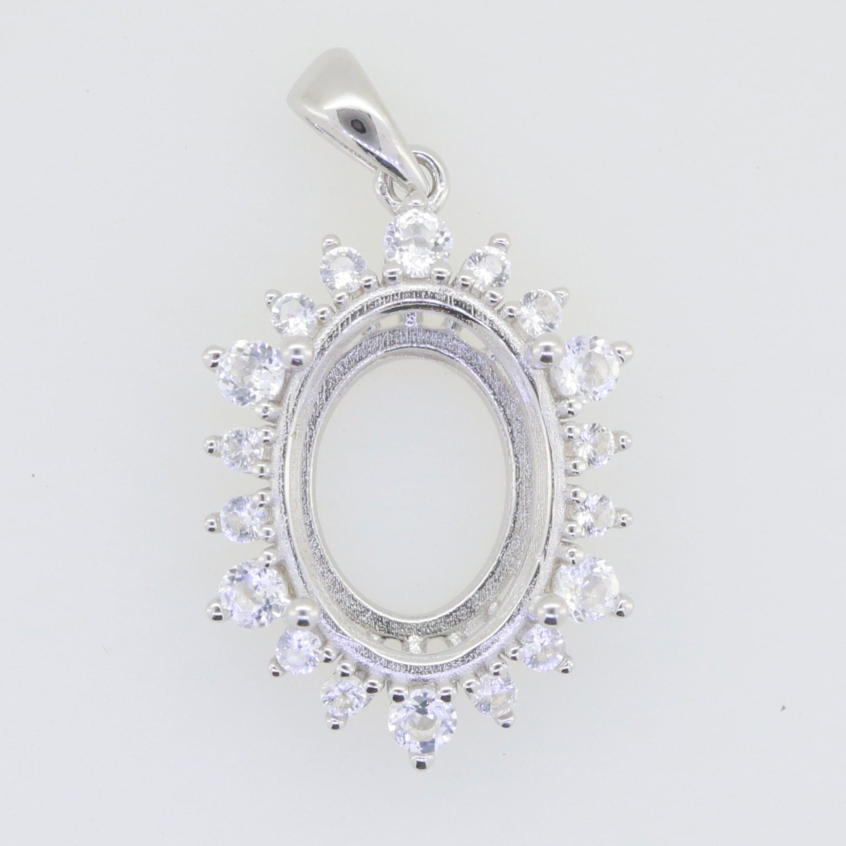 Sterling silver semi mount pendant setting with white topaz halo, oval design for customizable gemstone options.