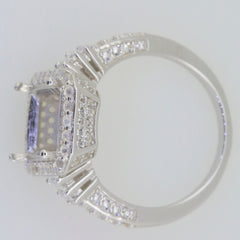 Sterling silver semi mount ring setting with halo of white topaz, designed for an emerald gemstone.