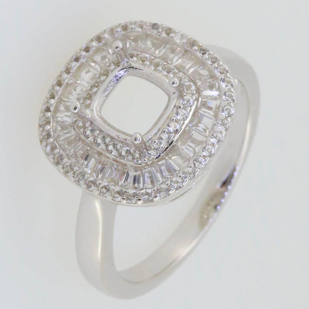Sterling silver semi mount ring setting with cushion shape, baguette triple halo, featuring white topaz gemstones.