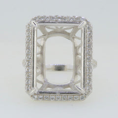 Sterling silver semi mount ring setting with halo of white topaz, designed for a 20x15mm emerald centerpiece.