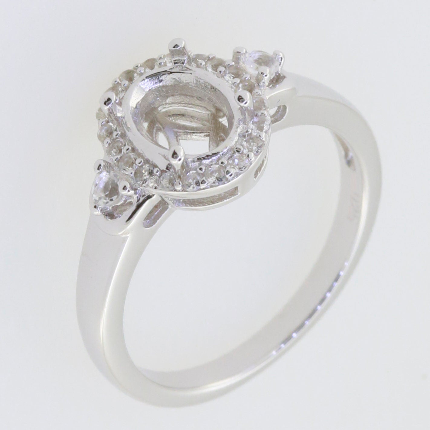 Sterling silver semi mount ring setting with D Color Moissanite accents, designed for an 8x6mm oval gemstone.