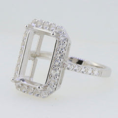 Sterling silver semi mount ring setting with halo, designed for 14x10mm emerald cut stone, featuring D Color Moissanite accents.