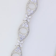 Sterling Silver semi mount tennis bracelet setting featuring oval shapes and white topaz accents, elegant jewelry design.